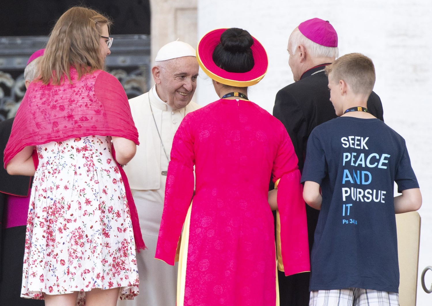 Pope Francis greets a prelate and young people during a special audience with altar servers July 31 in St. Peter’s Square at the Vatican.